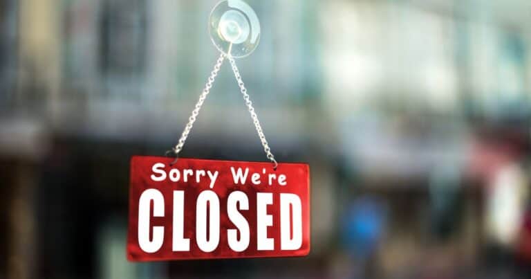 image showing a sign of sorry we're closed.