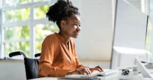 woman writing blog post on computer