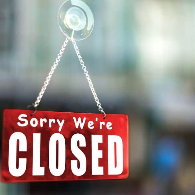 image showing a sign of sorry we're closed.